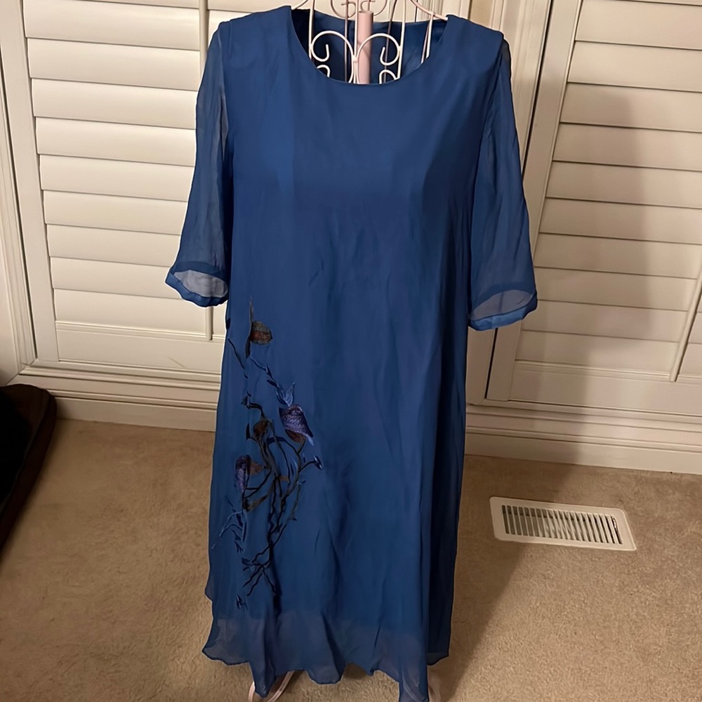 Chiffon blue silk dress with big embroider flowers on the right side.